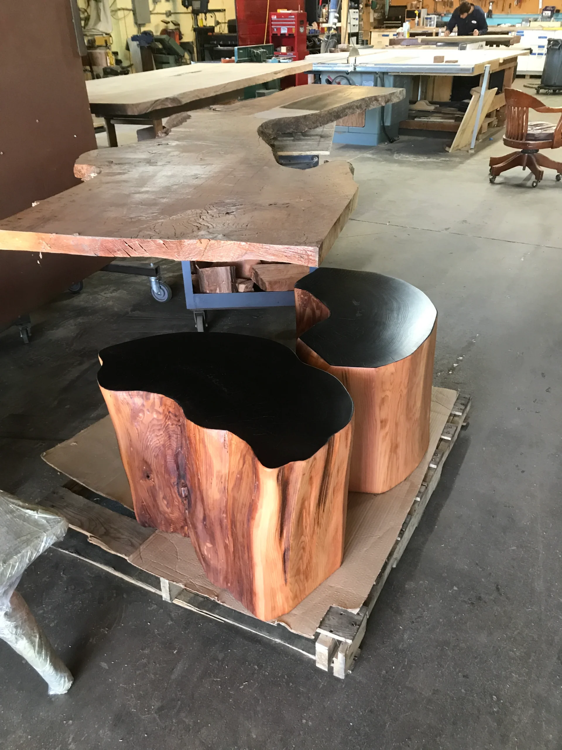 For the coffee table we used stone, shape was cut out on a waterjet machine and two cedar trunks that got stained with metal pigment paint.